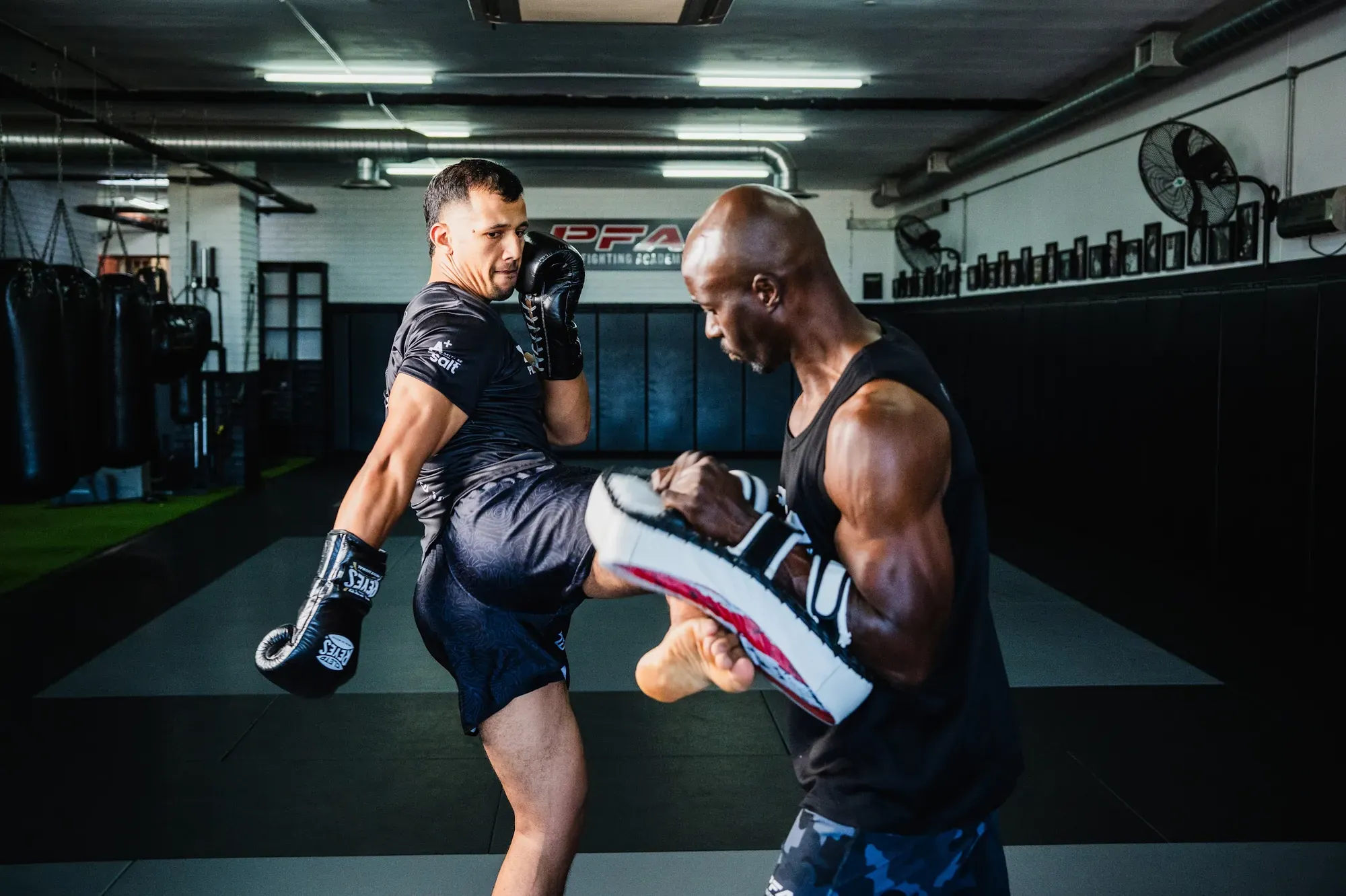 Coach holding pads for a Muay Thai knee strike