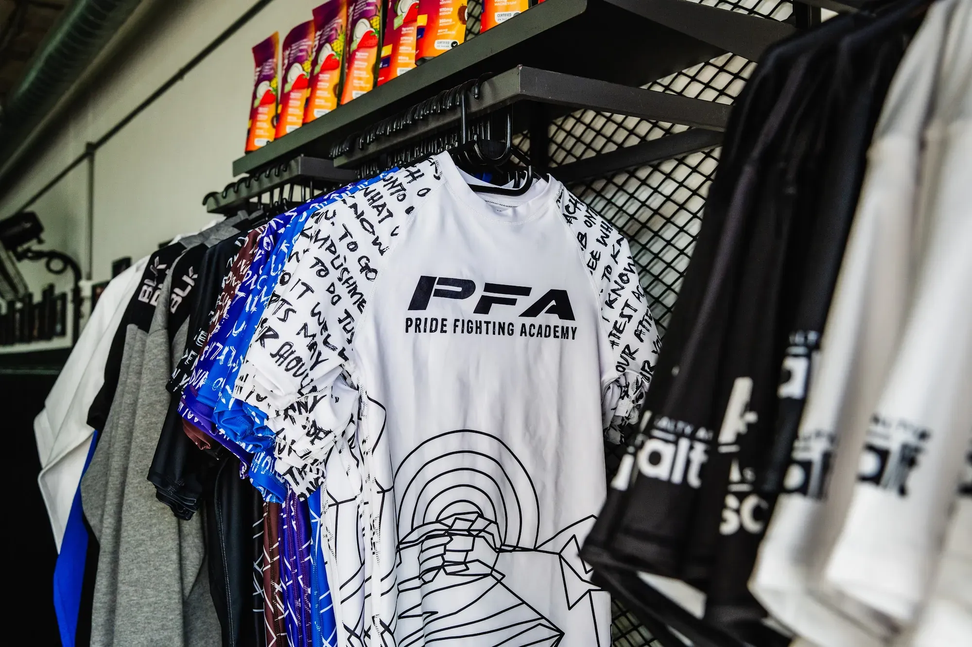 PFA rash guards and apparel on display in the shop